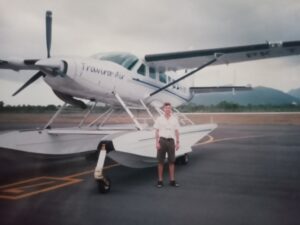 The founder next to an amphibian float plane